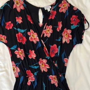Black floral romper. There are pockets! There is a hidden button near the bust.